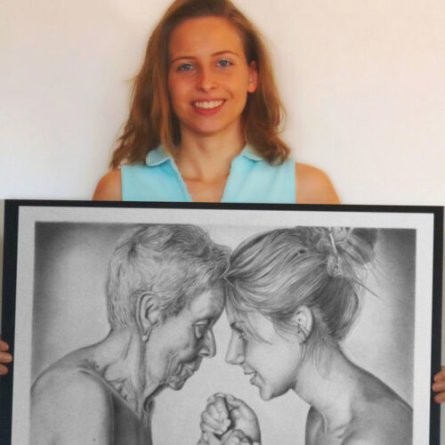 The artist with a realistic pencil drawing of an old and a young woman.